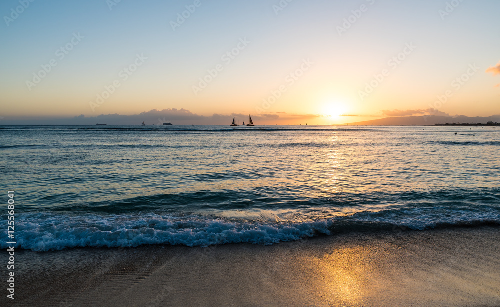 Sunset over Pacific Ocean viewed from Waikiki Beach Hawaii