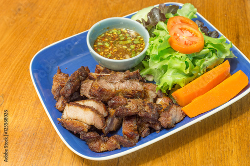 Charcoal-boiled pork neck and spicy sauce with vegetable in dish
