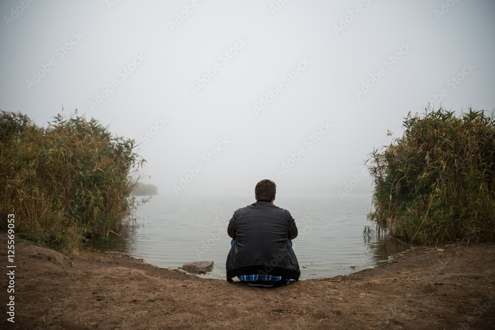 Fototapeta premium Young man near lake