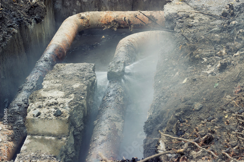  Broken old pipes of the heating system; water splashing 