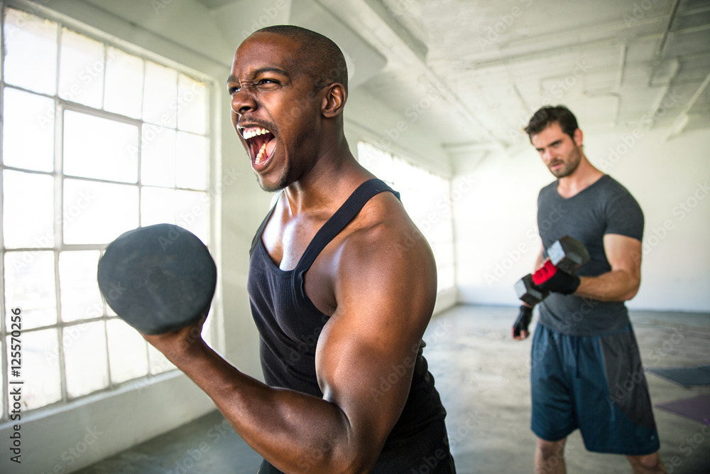 Obraz premium Inspirational empowering determination bodybuilder athlete showing resilience and power during workout