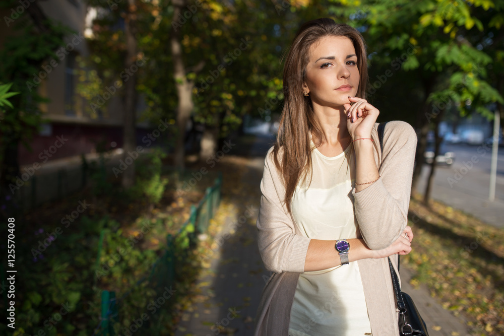 Portrait of beauty woman with perfect smile walking on the street and looking at camera, sunset light Portrait of beauty woman with perfect smile walking on the street and looking at camera, sunset light