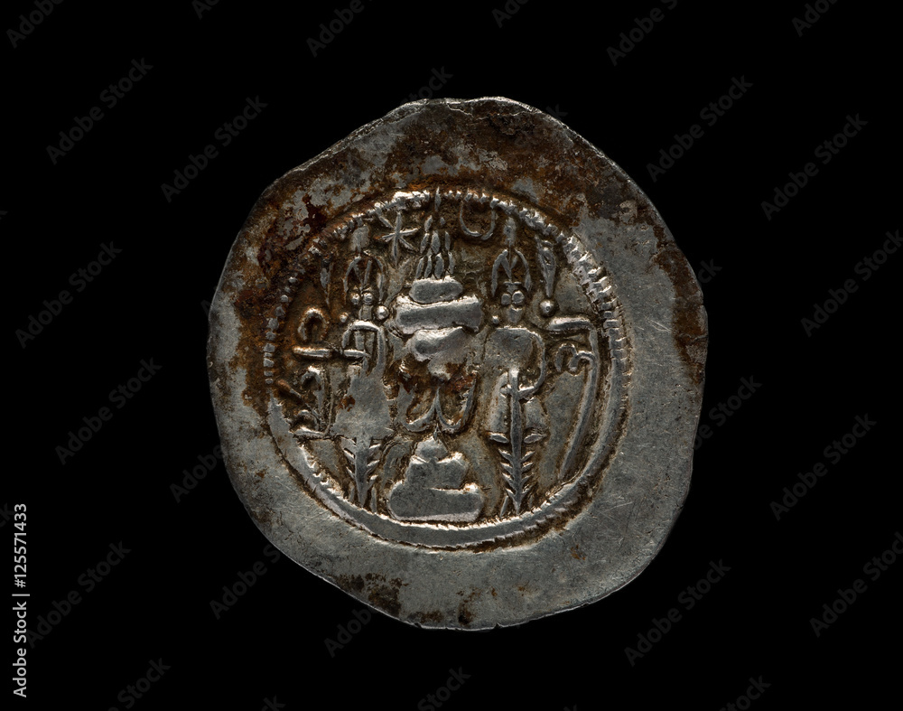 Ancient silver Sassanian coin with patina isolated on black Ancient silver Sassanian coin with patina isolated on black