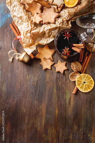 Hot mulled wine in a glass with orange slices, anise and cinnamo