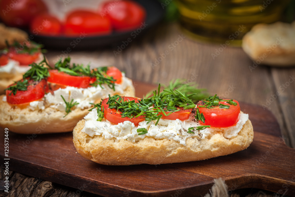 Delicious bruschetta with tomatoes, feta cheese, dill and spice