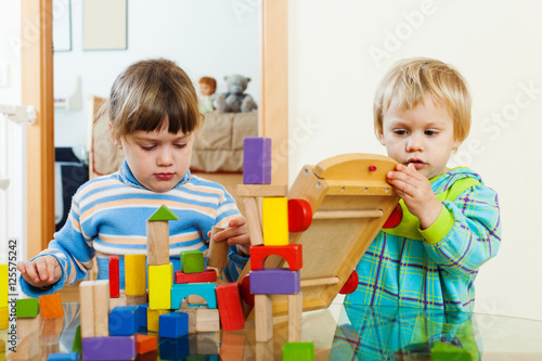calm children playing with wooden blocks