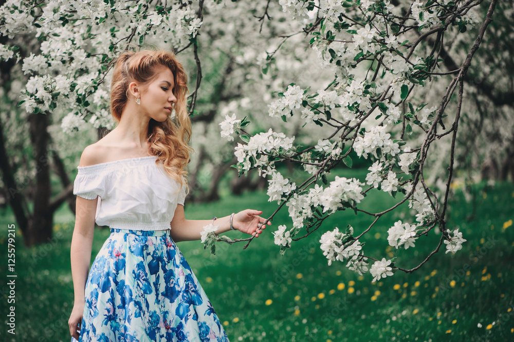 beautiful young woman in floral maxi skirt walking in spring Stock Photo Adobe Stock