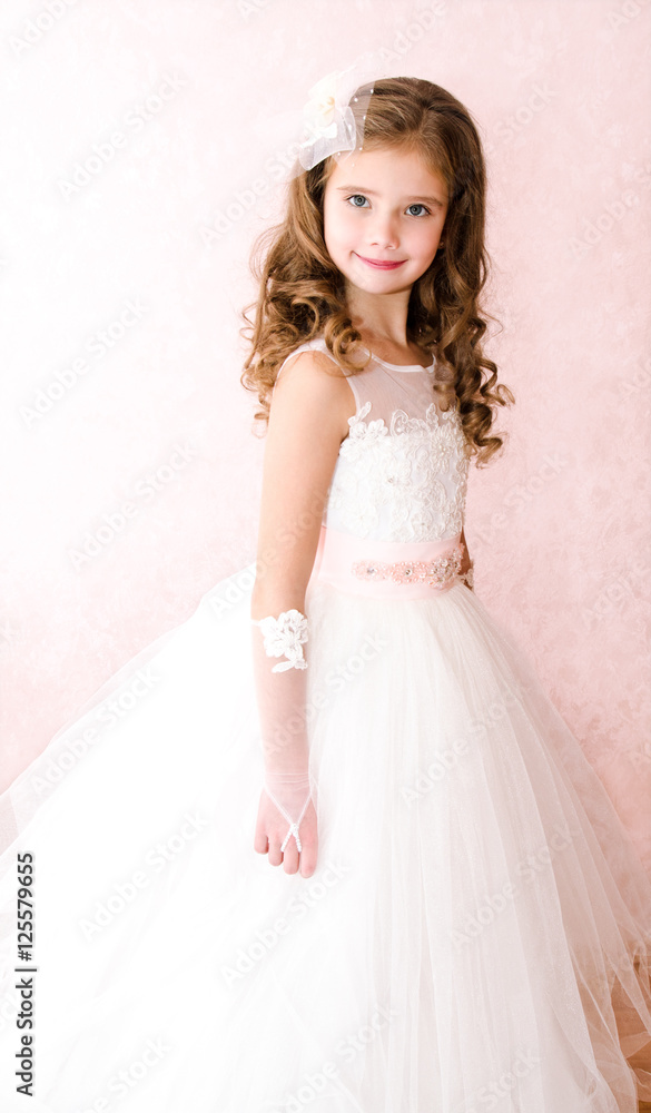 Adorable smiling little girl in white princess dress Adorable smiling little girl in white princess dress