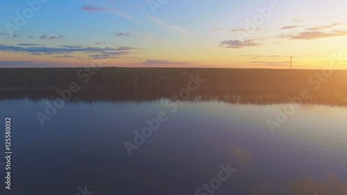 Wallpaper Mural Aerial Drone Flight Footage: Back Flight above calm Water and forest in sunset soft light. Magestic landscape. Colorful nature background. Kiev Sea, Ukraine, Europe. 4K resolution. Torontodigital.ca