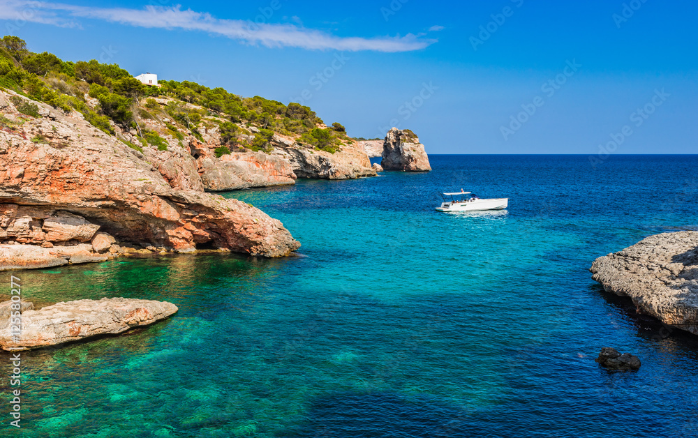 Idyllic mediterranean sea bay with boat at the coastline of Majora Spain
