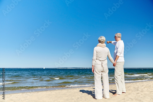 happy senior couple on summer beach