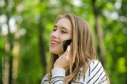 Wallpaper Mural Young woman using her phone Torontodigital.ca