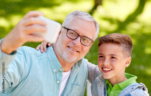 old man and boy taking selfie by smartphone © Syda Productions