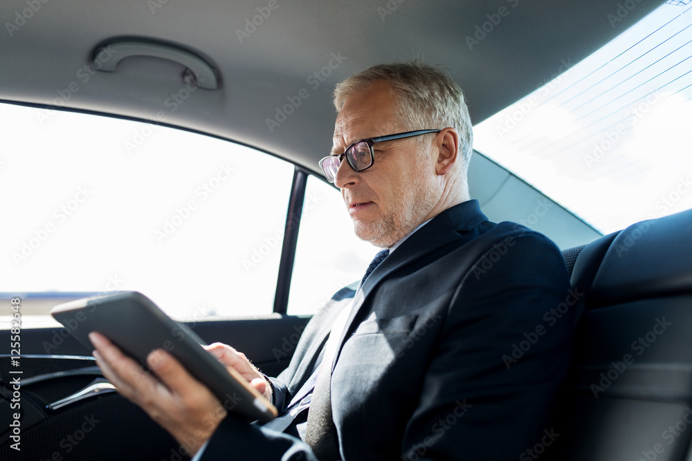 senior businessman with tablet pc driving in car senior businessman with tablet pc driving in car