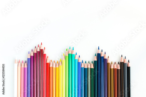 Crayons and watercolor pastels lined up isolated on white backgr