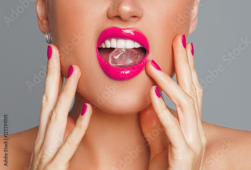 Close-up shot of woman's lips with ice cube

