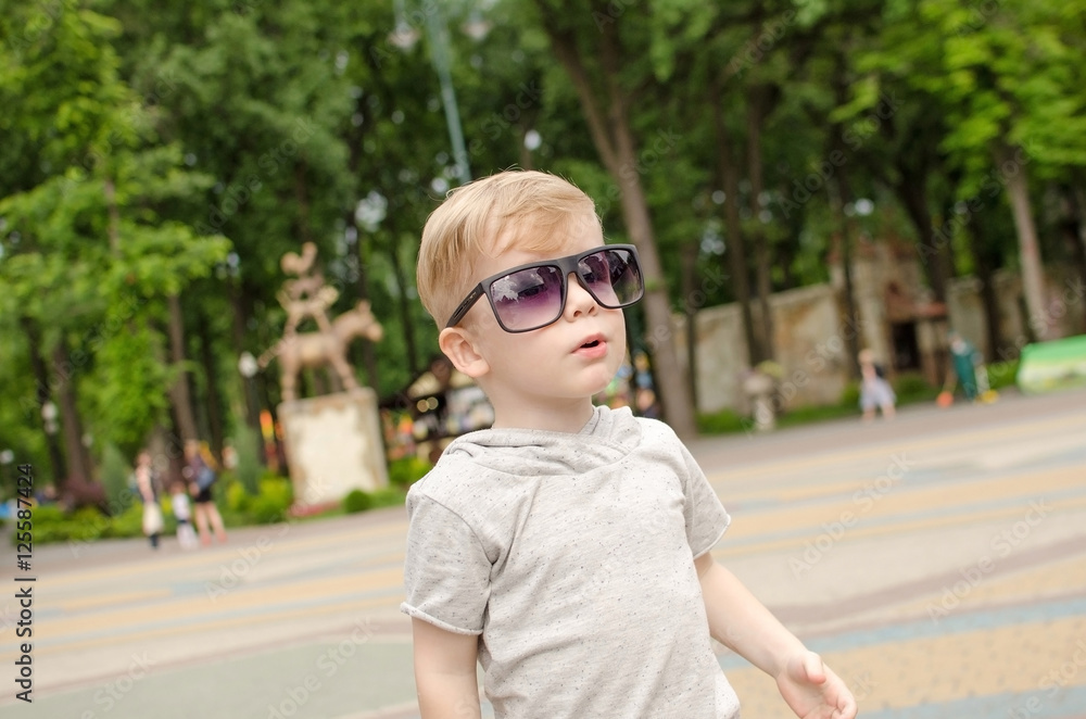 Small baby boy is faving fun in the park Small baby boy is faving fun in the park