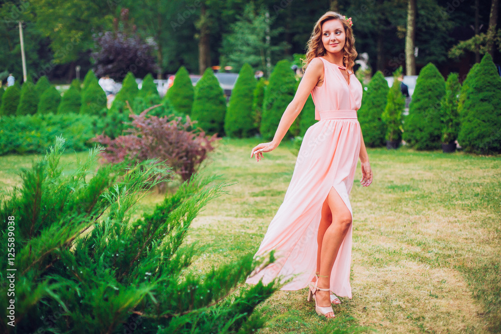 Beautiful bridesmaid in a pink dress. Autumn outdoor. Beautiful bridesmaid in a pink dress. Autumn outdoor.