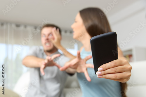 Couple fighting for a mobile phone photo