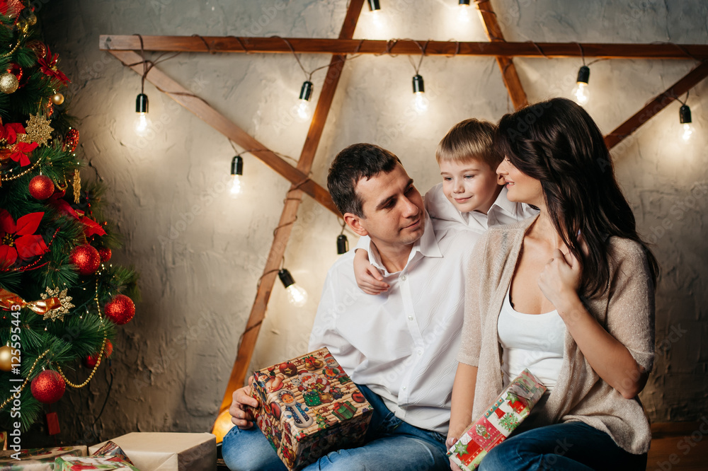 happy young family in Christmas decorations happy young family in Christmas decorations