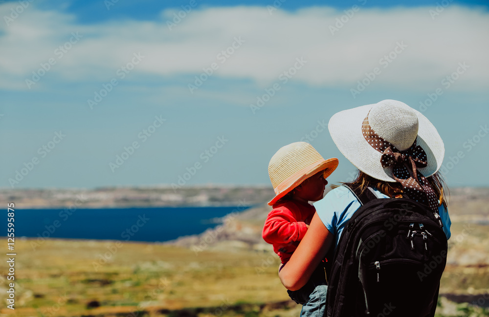 family travel - mother with little daughter looking at mountains family travel - mother with little daughter looking at mountains