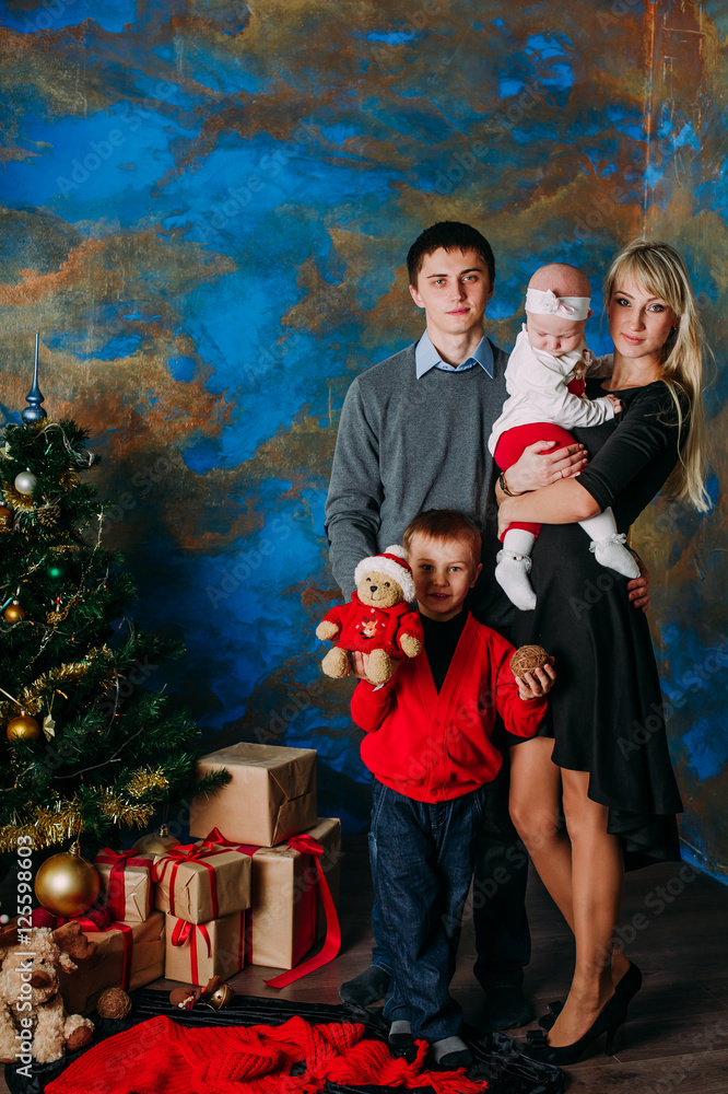 Portrait of friendly family looking at camera on Christmas evening Portrait of friendly family looking at camera on Christmas evening