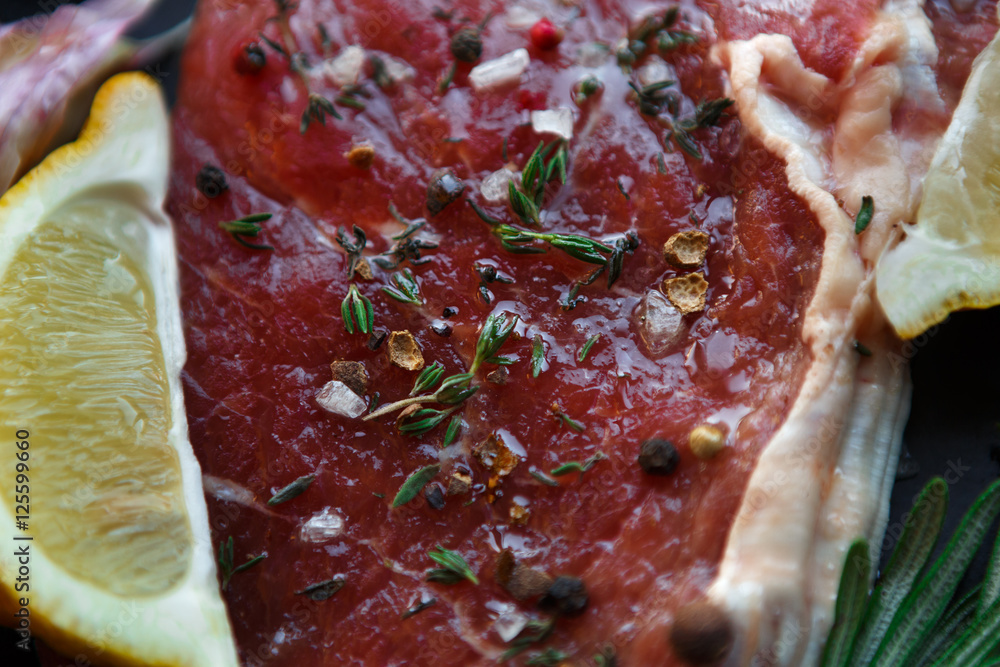 Raw beef steak closeup background with spices and herbs. Raw beef steak closeup background with spices and herbs.