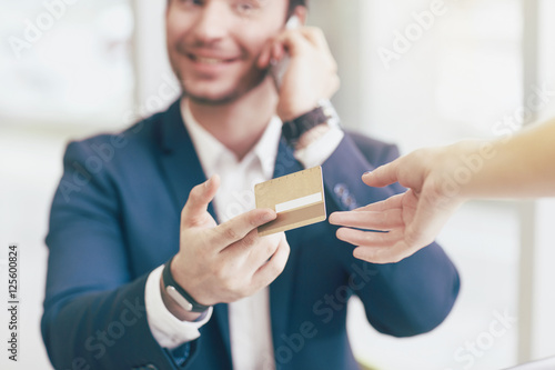 Businessman holding his credit card