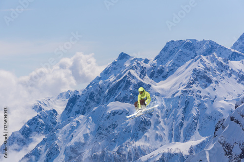 Ski rider jumping on mountains. Extreme freeride sport.