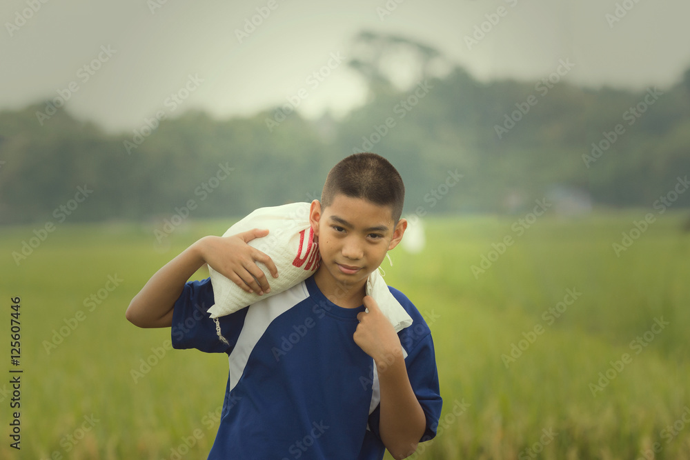 Fototapeta premium The face of boy has the drop of sweat represent his tired after working hard in his family farm