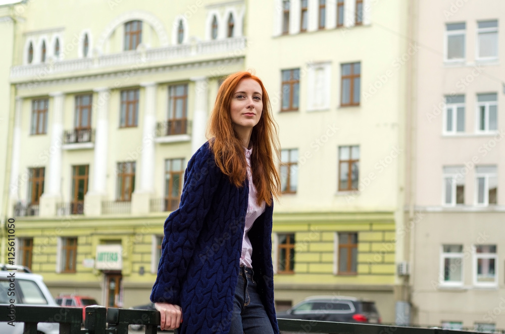 Young red woman walking in the city