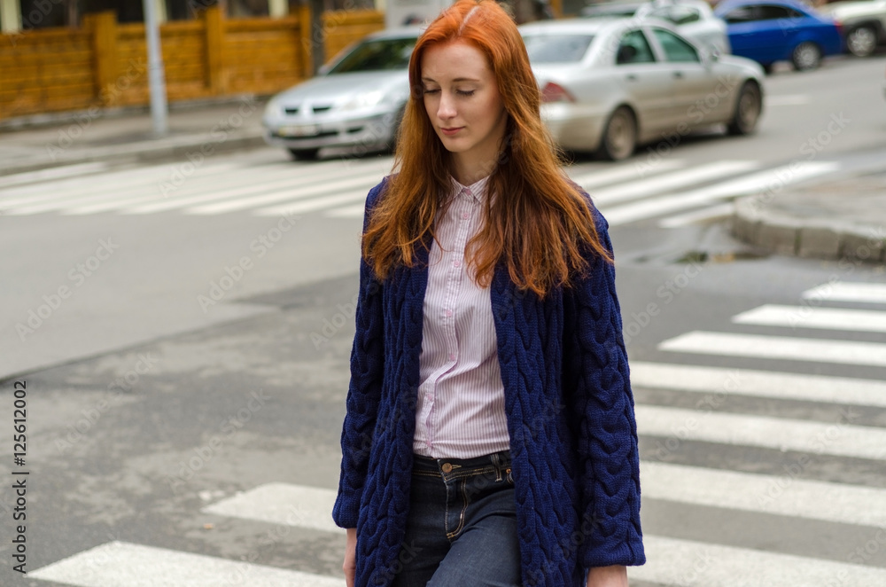 Young red woman walking in the city Young red woman walking in the city
