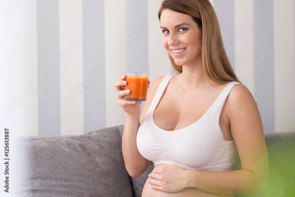 Pregnant woman drinking healthy cocktail Pregnant woman drinking healthy cocktail