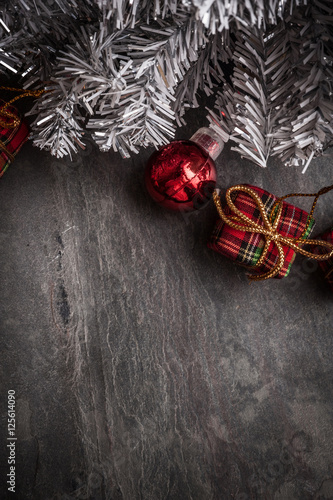 Christmas tree with decoration on dark stone background