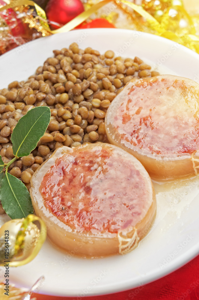 Italian cotechino with lentils on christmas table Italian cotechino with lentils on christmas table