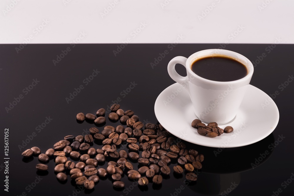Coffee cup with coffee beans surrounding Coffee cup with coffee beans surrounding