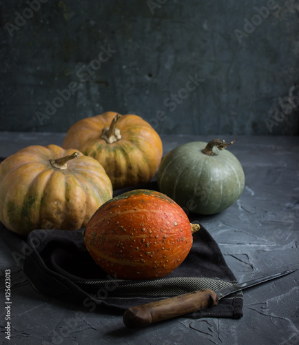 Fresh raw pumpkin on a dark background