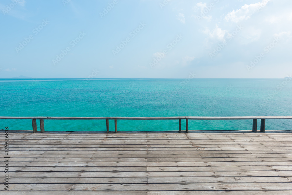 wooden floor with beautiful ocean and blue sky scenery