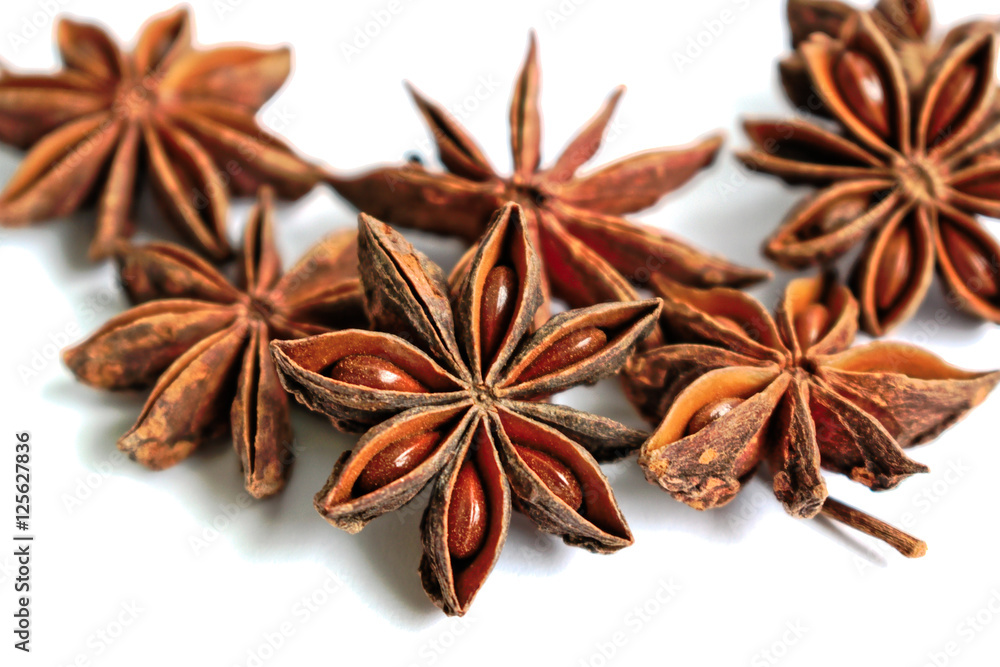 Star shaped anise seeds on a white background Star shaped anise seeds on a white background