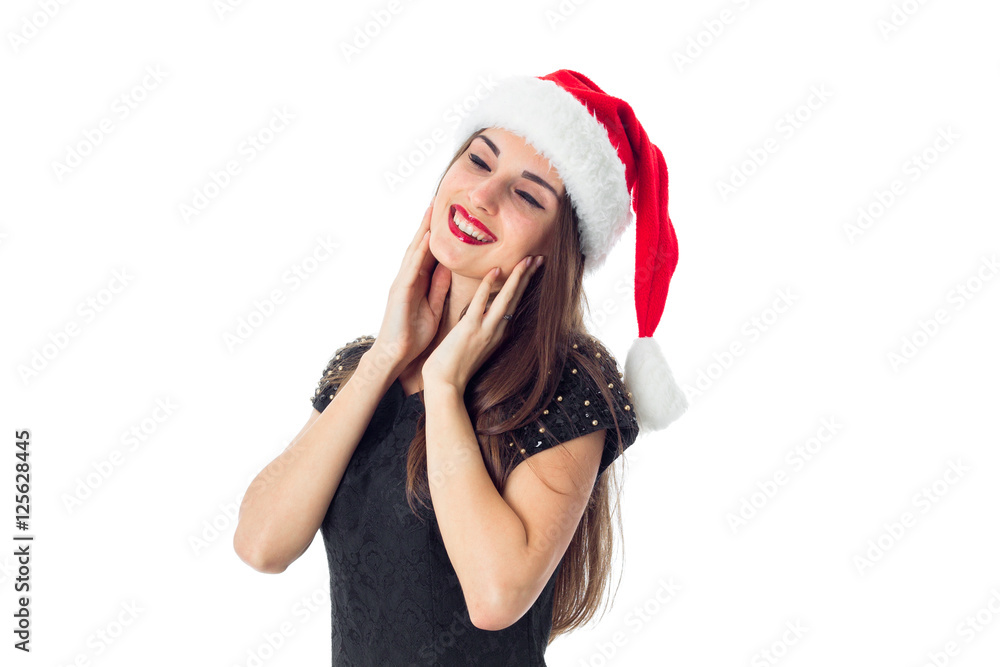 brunette girl in santa hat with closed eyes brunette girl in santa hat with closed eyes
