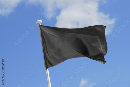 Fényképezés Cleared black flag waving on the wind