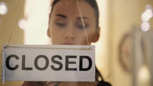 Open sign hanging on the door of shop