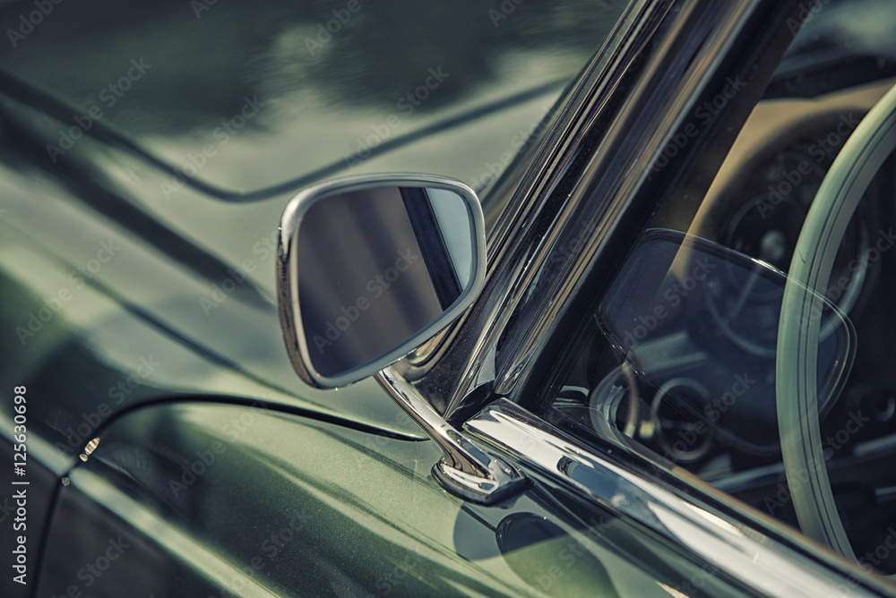 close up on Rear view mirror on greenv intage car.