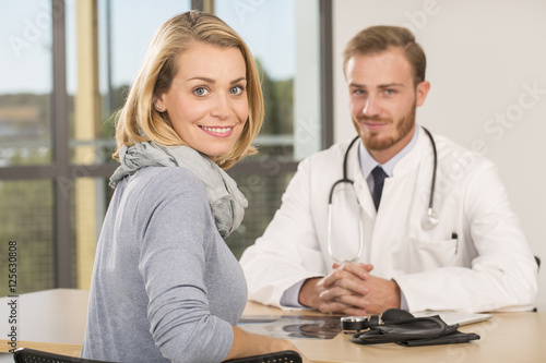 Doctor consulting patient in office