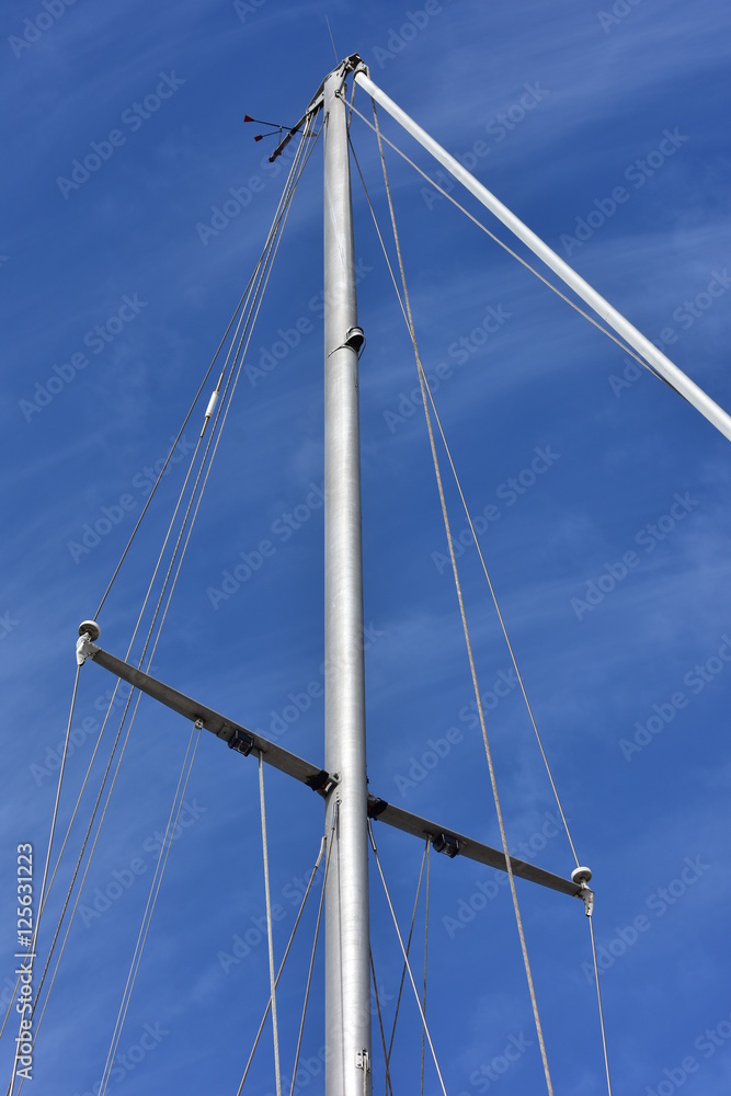 Metal oval profile yacht mast with cordage. Metal oval profile yacht mast with cordage.