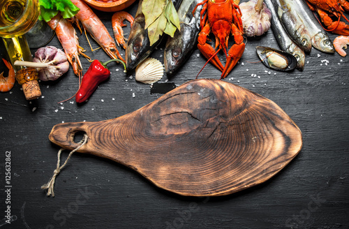 Cutting Board with a variety of shrimp, fish and shellfish.