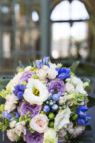 Romantic fresh wedding bouquet on background of house with windows