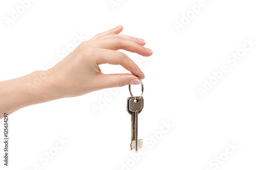 Female hand holds keys on white background.
