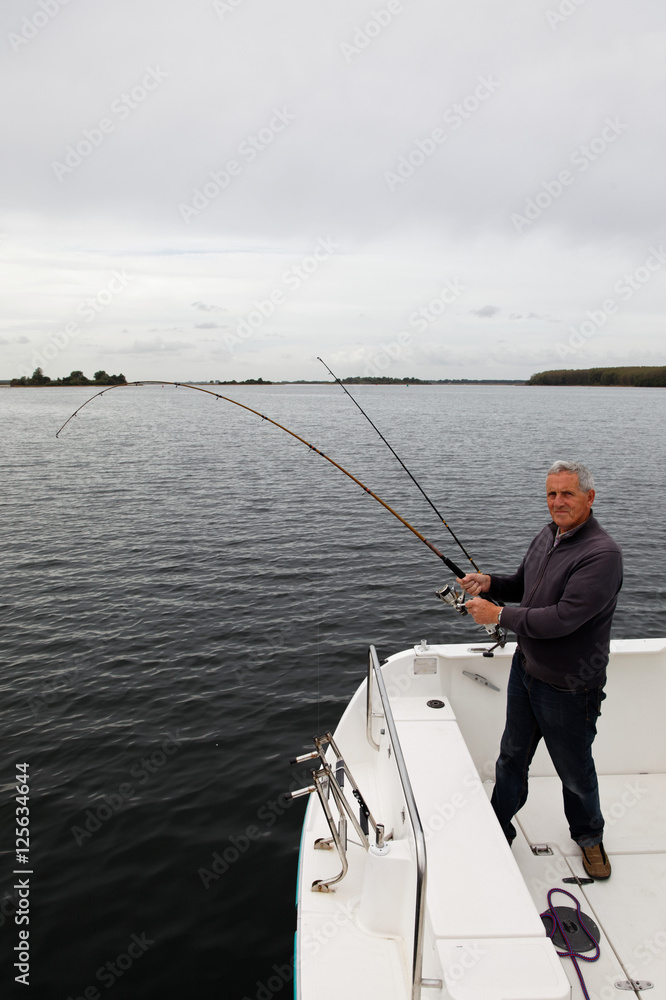 fiserman on a white boat is looking at you