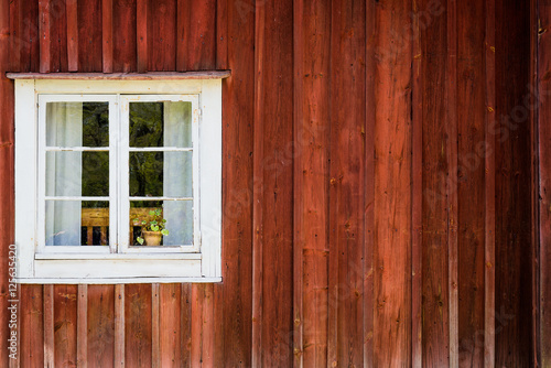 White window of a wooden house in Sweden